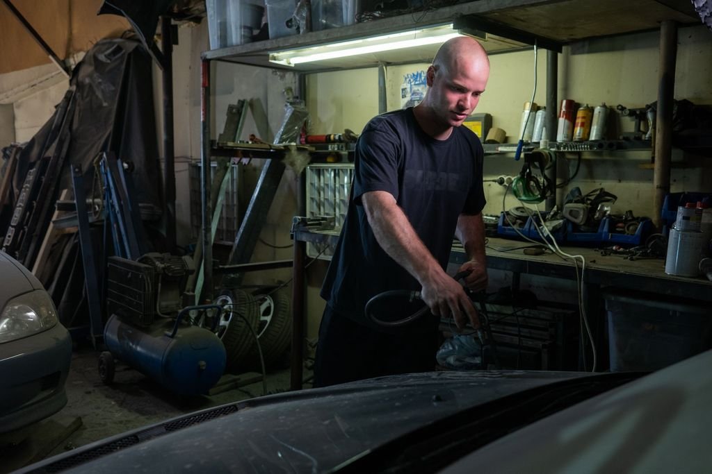 Auto mechanic working on a vehicle in a professional repair garage